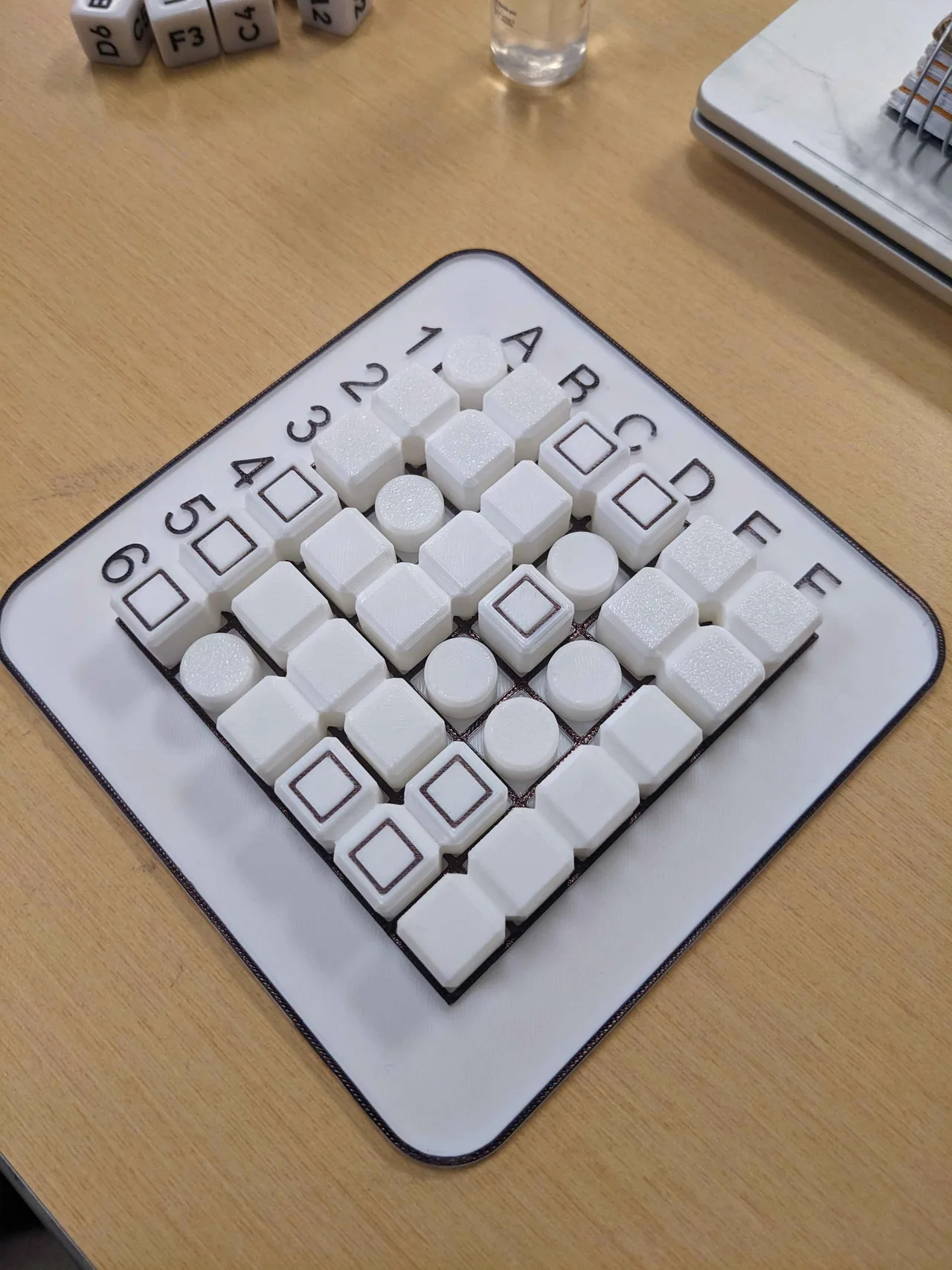 An angled view of the populated printed board with dice nearby