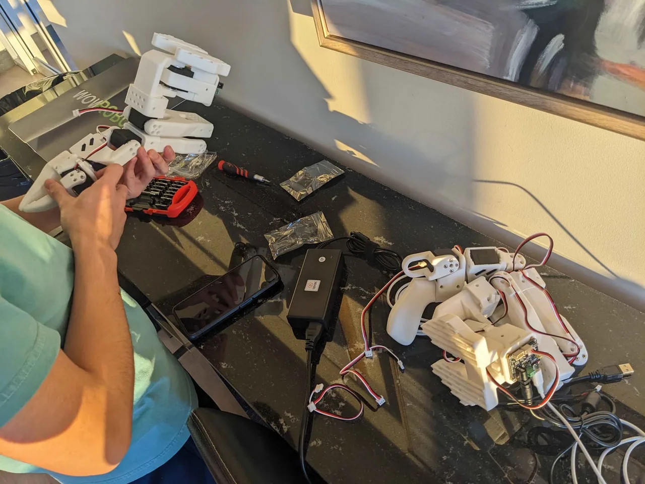 Calibrating the arms at a desk next to a laptop