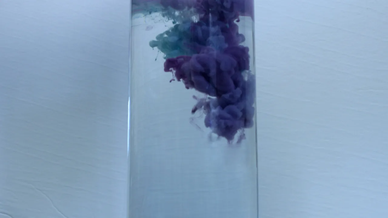 Purple colour dispersing through water