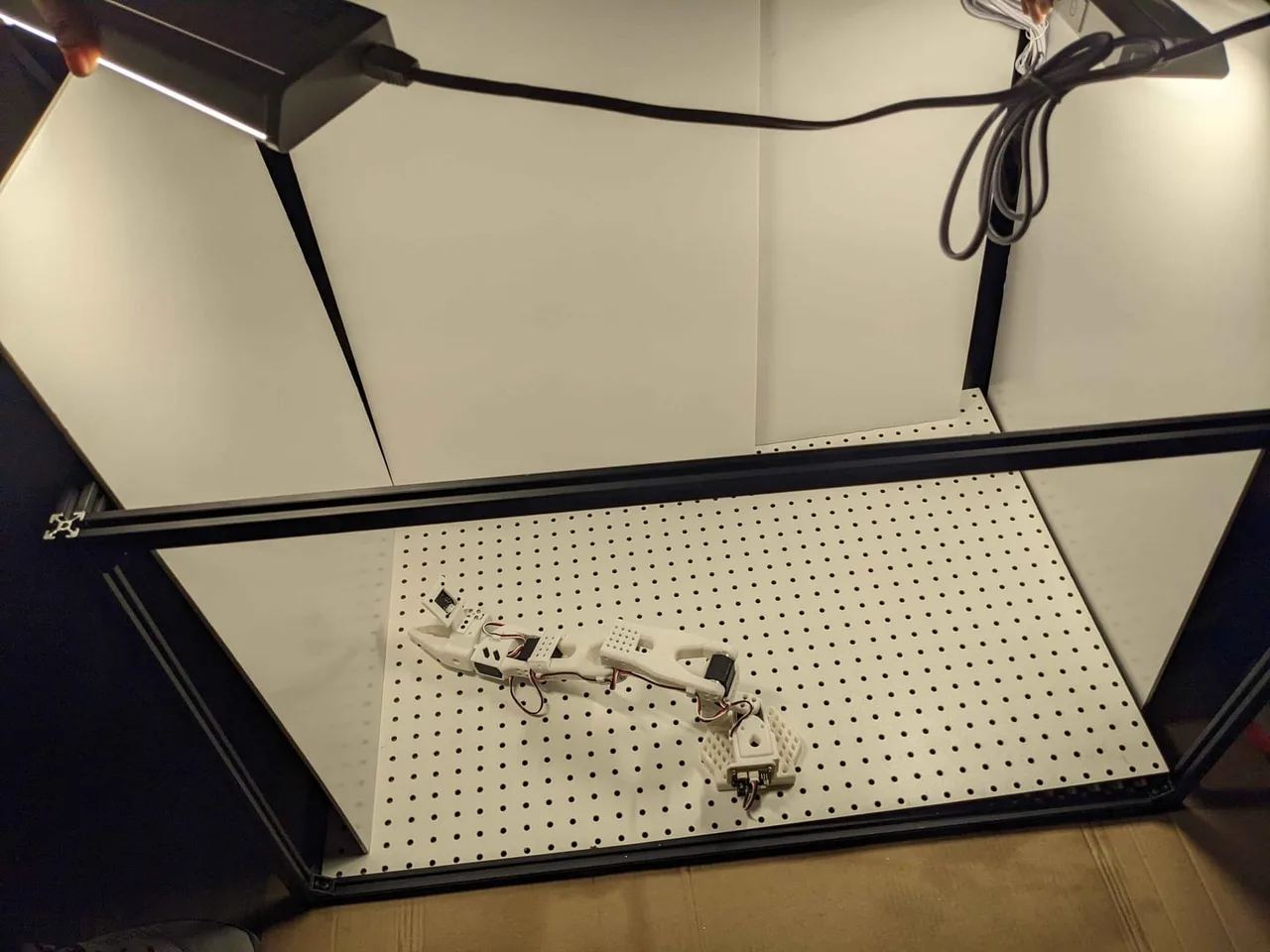 The enclosure lit from inside, with the follower arm on the deck