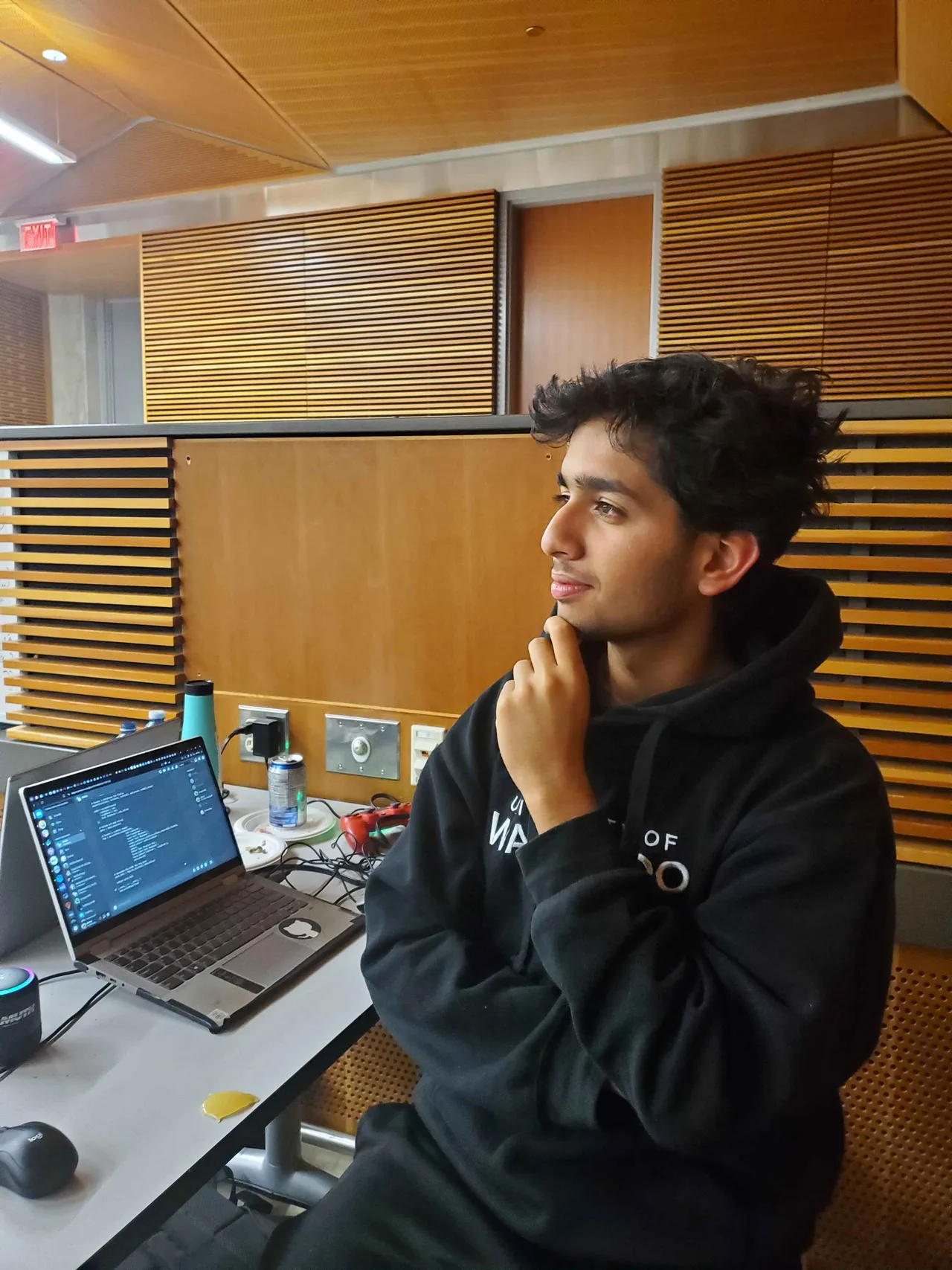 Team member working at a laptop in an auditorium