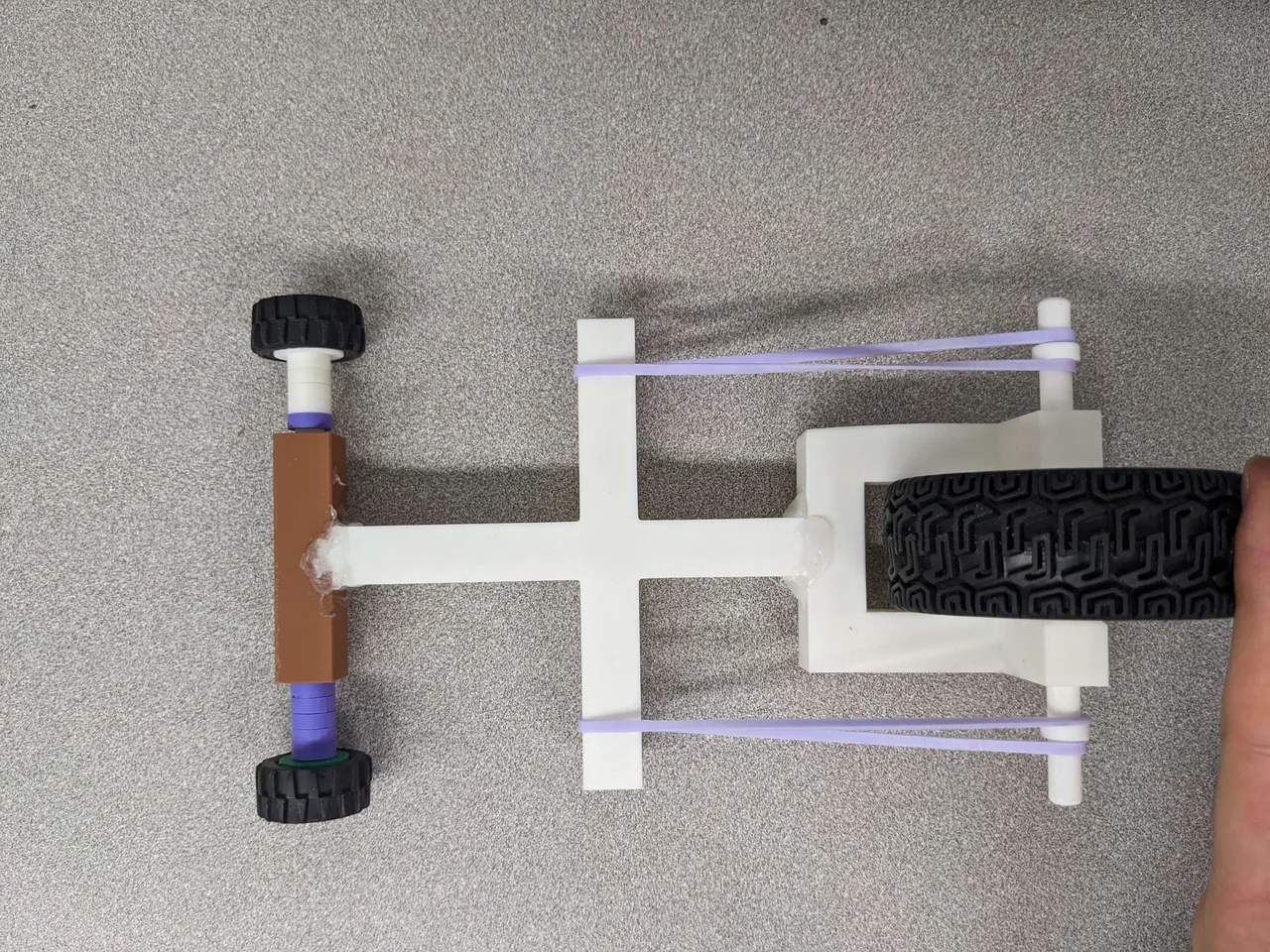Top view of the vehicle showing the three wheels and rubber-band routing